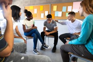 group of teens engaging in mindfulness circle session