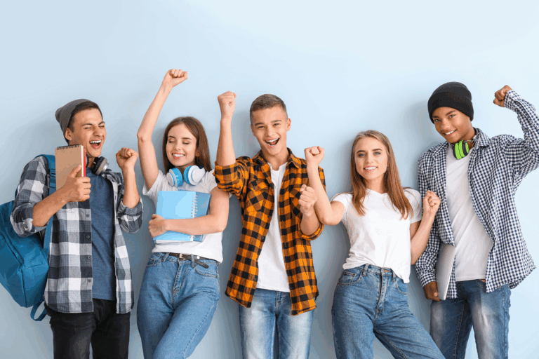 group of teens cheering at school