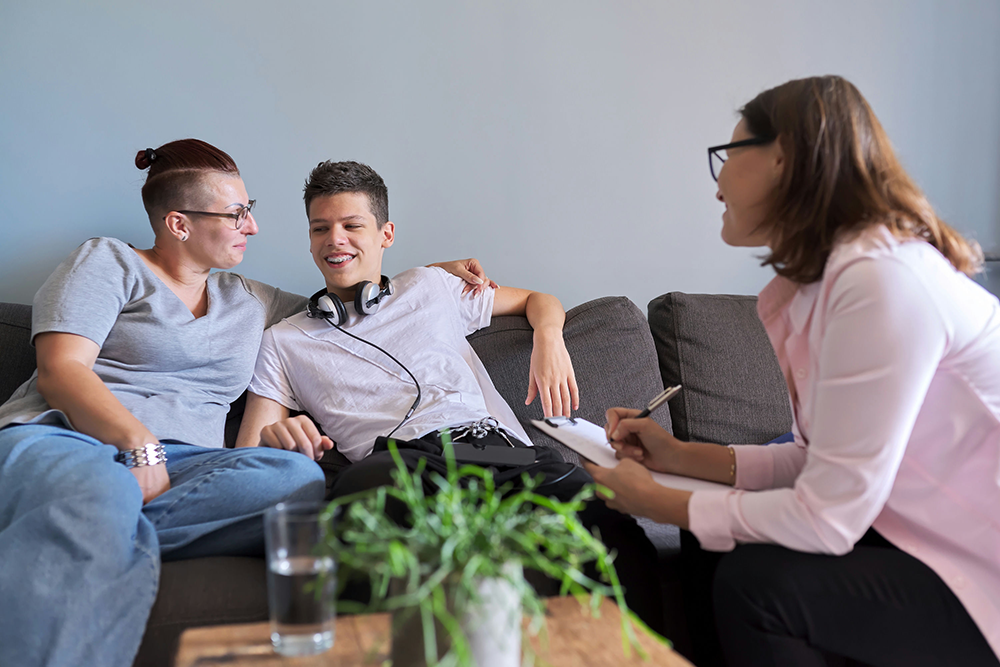 a-teen-boy-in-therapy-with-headphones-and-mom 