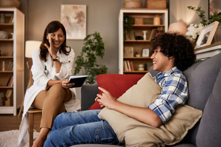 a-teen-boy-laughing-with-therapist