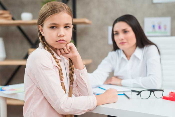 teen girl with ADHD guided by therapist in individual care