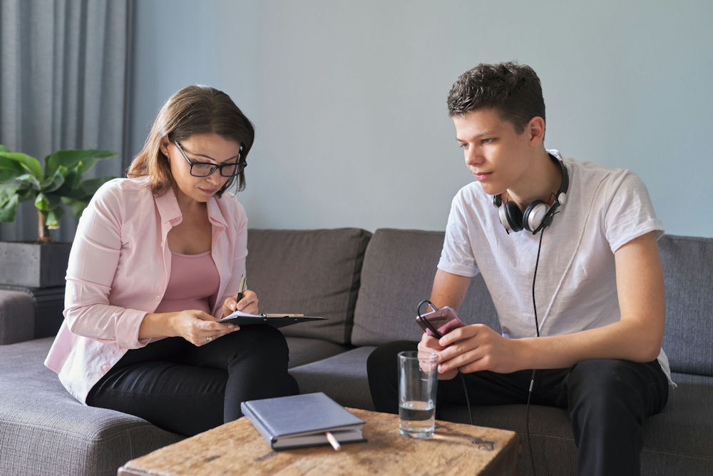 therapist gathering information from a boy during a CBT session in Redondo Beach