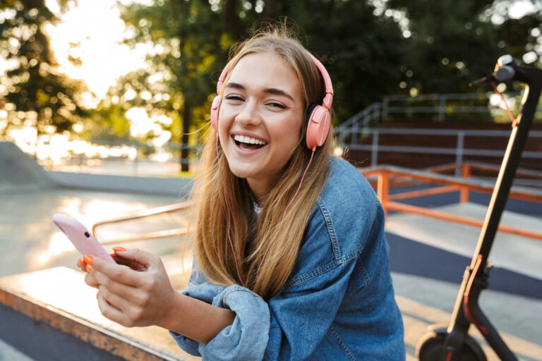 a teen listening to music smiling