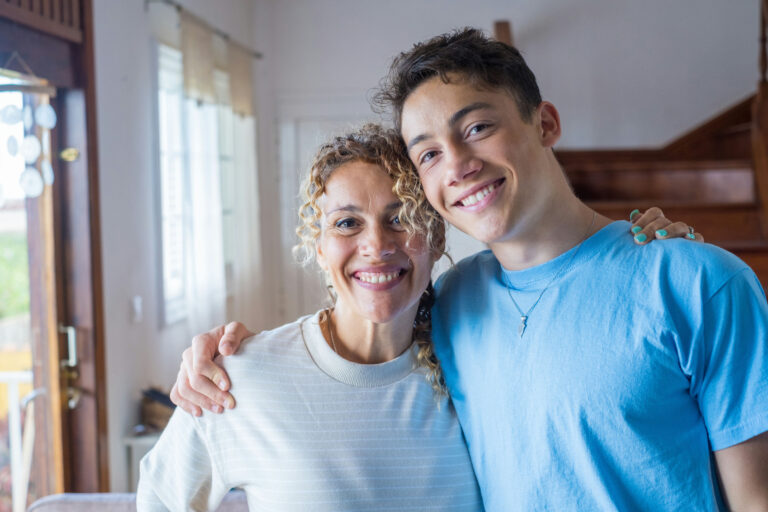 a-teen-boy-hugging-his-mom-smiling